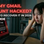 Woman worried about Gmail account hacking, computer screen showing security alert.